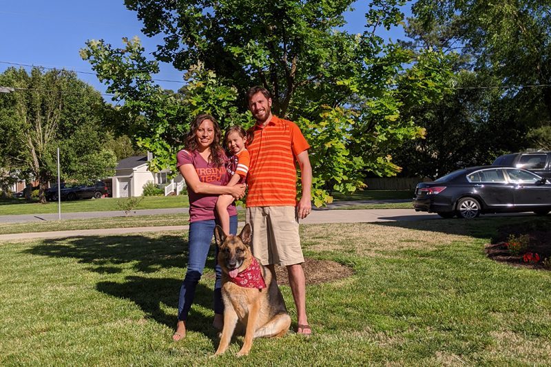 John, Carissa and Madelyn Hawley with their dog Django in front of their War Memorial oak
