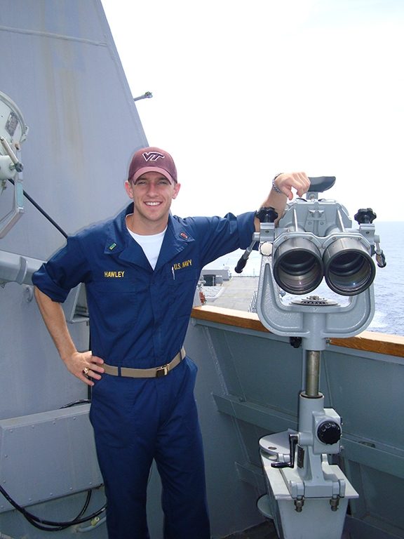 Young John Hawley in Navy coveralls and a maroon Virginia Tech cap aboard USS McCampbell